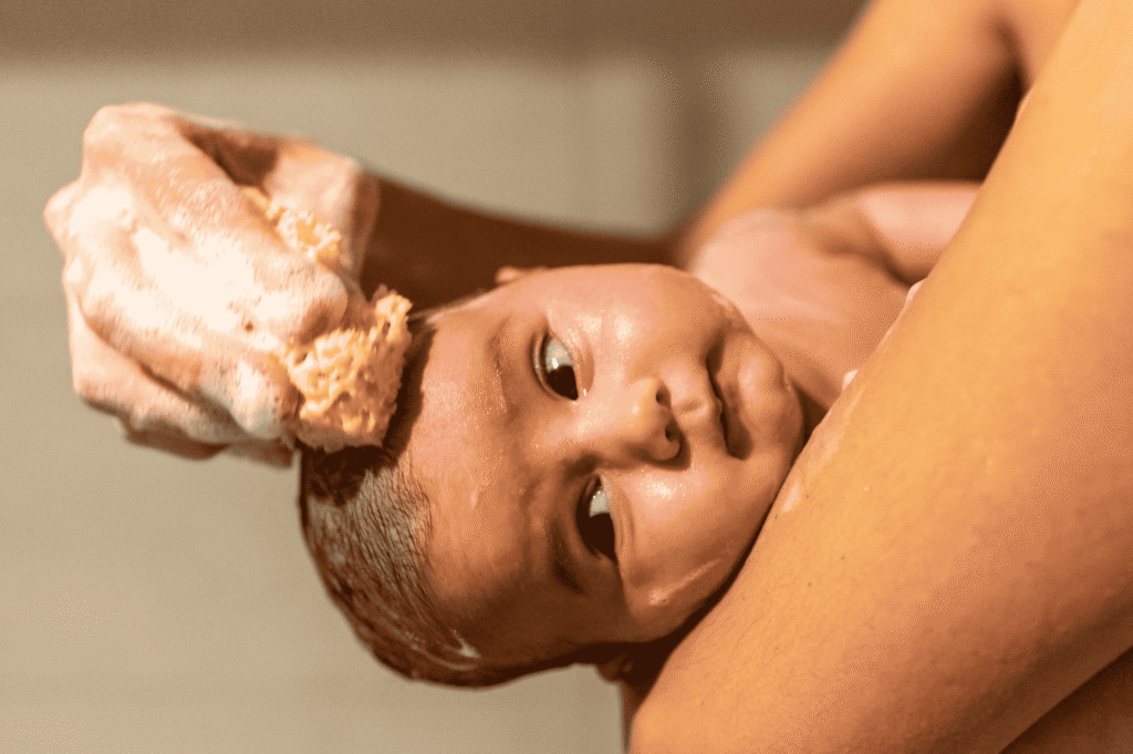 Bottled Water for Baby Baths using The Gulf Shower for a gentle and safe baby bath experience.