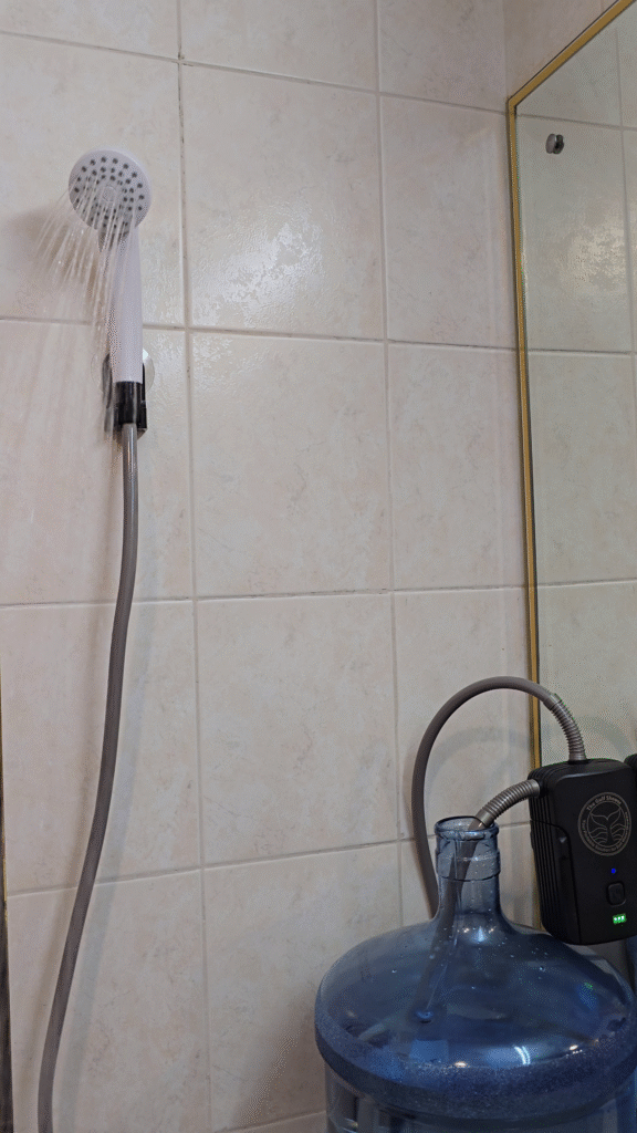 The gulf Shower Flex connected to bottled water gallon