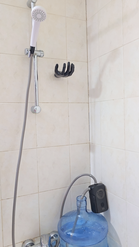 The gulf Shower Flex connected to bottled water gallon